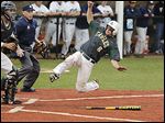 Clay’s Ty McAtee scores as St. John’s catcher Corey Tipton waits for the ball during the second inning of the Division I district semifinals at Mercy Field on Thursday. The Eagles won 5-0.