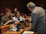  Denise Fox, of Aurora House, left, and Renee Palacios, of Family House, center, speaking with city council member George Sarantou.  
