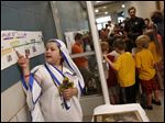  Isabella Karrip, 10, left, spoke about the life of Mother Teresa as she played the nun during the, 