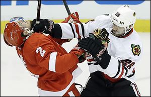 Chicago Blackhawks center Michal Handzus mixes it up with Detroit's Brendan Smith during the second period.