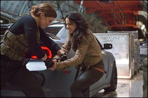 Gina Carano, left, and Michelle Rodriguez in a scene from 