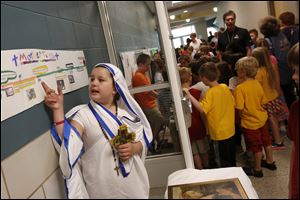 Isabella Karrip, 10, left, spoke about the life of Mother Teresa as she played the nun during the, 