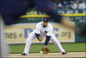 Detroit Tigers third baseman Miguel Cabrera fields an out from Minnesota Twins' Jamey Carroll during the first inning of a baseball game in Detroit, Thursday, May 23, 2013. (AP Photo/Carlos Osorio)
