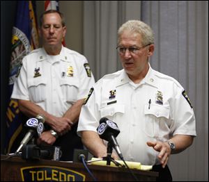 Toledo Deputy Police Chief Don Kenney talks during a news conference at the Safety Building about the shooting of Thomas Bean by Toledo police officers today. Captain Brad Weis is at back left.