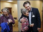  Dr. Lawrence Elmer hugs Jo Stockstiel of Holland during the open house of the Gardner-McMaster Parkinson Center at the University of Toledo's Health Science Campus. The advanced clinical treatment facility aims to be one of the nation’s leading Parkinson’s centers.