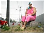  Jackie Chandler believes gang violence will grow.  She sits near flowers for La’Quan Dunbar, who was best friends with her nephew. Both men were shot to death. 