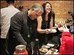  Gus Mancy, co-owner of Mancy Steakhouse, left, and Rose Keller serve up food at the Jam City! fund-raiser at Blarney Irish Pub in downtown Toledo.