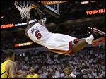  Miami Heat forward LeBron James (6) hangs from the basket after dunking the ball during the second half.