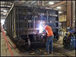  John Spurlock welds on a  railcar at The Andersons’ railcar-repair facility in Maumee. The Ander­sons’ rev­e­nues rose sig­nifi­cantly in 2012 to $5.3 bil­lion from $4.6 bil­lion in 2011. Fueling that rise was the growth in its grain, ethanol, and plant-nutrient divisions. 
