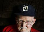  Ken Silverthorne, 93, holds a Mud Hens team photo from the 1930s, one of his prized possessions.