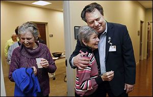 Dr. Lawrence Elmer hugs Jo Stockstiel of Holland during the open house of the Gardner-McMaster Parkinson Center at the University of Toledo's Health Science Campus. The advanced clinical treatment facility aims to be one of the nation’s leading Parkinson’s centers.