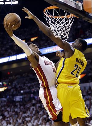 Miami Heat guard Norris Cole (30) attempts to score around Indiana Pacers center Ian Mahinmi (28) during the second half of Game 2 in their NBA basketball Eastern Conference finals playoff series, Friday, May 24, 2013, in Miami. (AP Photo/Lynne Sladky)