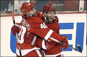 The Red Wings' Daniel Cleary, right, celebrates his empty-net goal with teammate Henrik Zetterberg. The veteran right wing said his team feels good with a 3-1 series lead.
