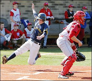 Whitmer's Kyle Craig scores behind St. Francis catcher Michael Wagner in Friday's district semifinal.