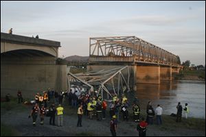 A portion of the Interstate-5 bridge is submerged after it collapsed into the Skagit river dumping vehicles and people into the water Thursday in Mount Vernon, Wash.