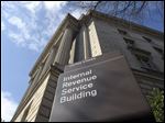  FILE - This March 22, 2013 file photo shows the exterior of the Internal Revenue Service building in Washington. No one answered the phone at the IRS hotline for tax help. Forget about advice on avoiding foreclosures at one of the Housing and Urban Development offices nationwide. Roughly five percent of the federal workforce _ 115,000 people at six government agencies _ got an unpaid day off on Friday due to the automatic cuts to the government budget. The furloughs forced some agencies such as the IRS and HUD to drastically scale back operations.  (AP Photo/Susan Walsh, File)