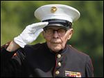  Marine Corporal Bob Romaker, 86, salutes.