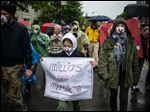  People carry signs during a protest against Monsanto in Montpelier, Vt. Marches and rallies against seed giant Monsanto were held across the U.S. and in dozens of other countries Saturday. 