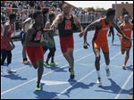  Rogers'  Kurtis Jefferies hands off to Michael Lipkins and Southview's Jeremy Cook hands off to J.J. Pinckney in the 1600-meter relay won by the Cougars.