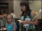  Allison Herr, 9, left, and her mother Jenny Herr, of Metamora, at a reception following the memorial service. Allison received a liver after being on the transplant waiting list for one year and nine months.  