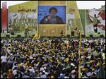  Hezbollah leader Sheik Hassan Nasrallah says Hezbollah members are fighting in Syria against Islamic extremists who pose a danger to Lebanon, confirming publicly for the first time that his men were fighting in Syria. Arabic writing at left reads, 
