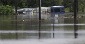 A San Antonio metro bus sits in floodwaters after it was swept off the road.