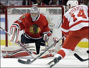 Chicago goaltender Corey Crawford blocks a shot by Detroit's Gustav Nyquist in Game 5 of the Western Conference semifinals.