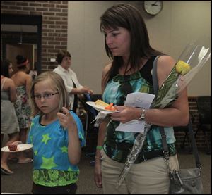 Allison Herr, 9, left, and her mother Jenny Herr, of Metamora, at a reception following the memorial service. Allison received a liver after being on the transplant waiting list for one year and nine months.  