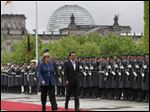  German Chancellor Angela Merkel, left, welcomes the Prime Minister of China  Li Keqiang  for a meeting at the chancellery Sunday in Berlin.