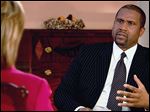  PBS host Tavis Smiley, right, during an interview with Hillary Rodham Clinton on 'Tavis Smiley Reports.' Smiley is marking his 10th year this month as host of his PBS talk show.