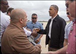 President Obama greets people on the tarmac as he arrives at Tinker Air Force Base in Midwest City, Okla., en route to the Moore, Okla., to see the response to the severe tornadoes and weather that devastated the area.