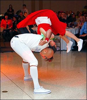 Bruce Gradkowski shows some of his athletic ability as he flips his partner Misha Brewer during their performance.