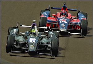 Tony Kanaan pumps his fist in front of Marco Andretti after winning the Indianapolis 500. There were a record 68 lead changes in the race.