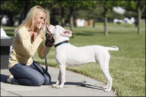 Angi Holt-Parks teaches Rudi, who is deaf,  to kiss her by signing the word ‘love’ at Friendship Park Community Center.