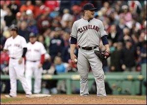 Cleveland Indians relief pitcher Joe Smith, foreground, looks toward home before taking the mound and throwing one pitch, a walkoff two-run double to Boston Red Sox's Jacoby Ellsbury.