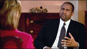 PBS host Tavis Smiley, right, during an interview with Hillary Rodham Clinton on 'Tavis Smiley Reports.' Smiley is marking his 10th year this month as host of his PBS talk show.