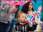  Aryana Smith, 2, left, and Amara Perez, right, 6, wave as the parade passes by.