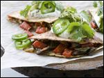  Mushroom, pepper and onion quesadillas are shown in Concord, N.H. Full-fat cheese is the secret to a flavorful recipe.
