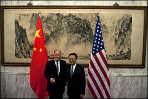U.S. National Security Adviser Tom Donilon, left, and Chinese State Councilor Yang Jiechi, right, shake hands before their meeting at Diaoyutai State Guesthouse in Beijing, China, today.