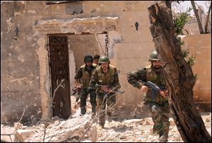 Syrian forces loyal to Syrian President Bashar Assad run to take their position during clashes against Syrian rebels, in Aleppo, Sunday.