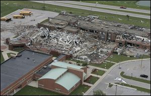 Damaged school buses sit next to Lake High School in Lake Township in Wood County, Ohio, Sunday, June 6, 2010, after it was destroyed by a tornado.