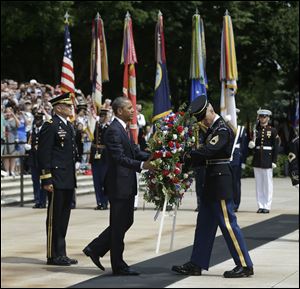 President Obama, center, participates in the wreathlaying ceremony at the Tomb of the Unknowns with Maj. Gen. Michael S. Linnington, left, Commander of the U.S. Army Military District of Washington, at Arlington National Cemetery on Memorial Day.