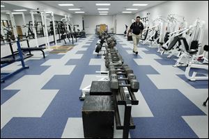 Eric Hirzel, school board vice-president walks through the weight room during a tour of the new Lake High School on August 1, 2012.
