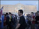   Member of pro-communist union PAME  chant anti austerity slogans outside the Greek parliament during a protest in Athens, last Thursday.