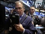  FILE - In this May 23, 2013 file photo, Trader Thomas Kay, left, works on the floor of the New York Stock Exchange Thursday, May 23, 2013. U.S. stock futures are moving sharply higher Tuesday, May 28, 2013, to start the week after the three-day holiday weekend and ahead of the latest update on the mood of the American consumer. (AP Photo/Richard Drew, File)