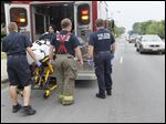  Authorities put Dorian Hester, 19, into an ambulance after a shooting on the corner of Evans and South Cove Blv.