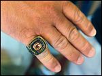  Brian Jackson shows the championship ring awarded  to Gibsonburg after winning the state Division IV championship. Jackson was an assistant coach for the 2005 Golden Bears. 