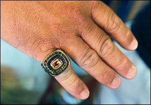 Brian Jackson shows the championship ring awarded  to Gibsonburg after winning the state Division IV championship. Jackson was an assistant coach for the 2005 Golden Bears. 