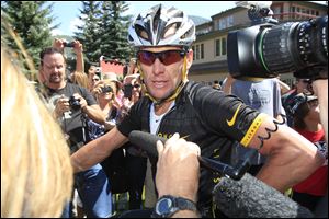 Lance Armstrong, the cyclist who admitted to cheating with drugs, reached an undisclosed settlement with The Sunday Times after it sued him for $1.56 million, the newspaper reported.