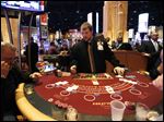  Bedford, Mich. resident Greg Stockard deals cards at a blackjack table during the Hollywood Casino one year anniversary celebration Friday.